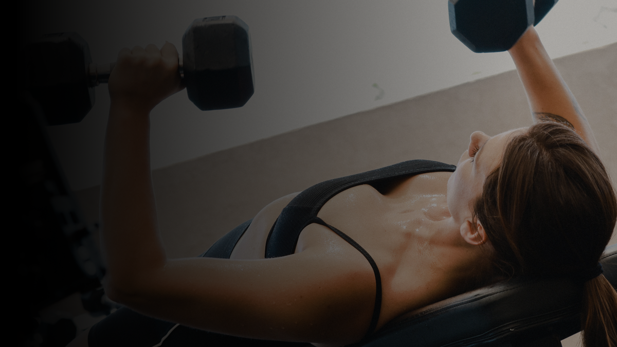 Fitness facility staff cleaning gym equipment with plant-based bulk wipes